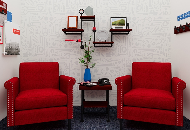 REED Manufacturing lobby with two red lounge chairs and a wall shelf and side table made of metal piping
