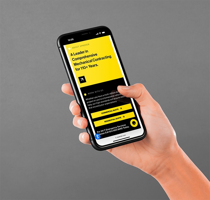 Hand holding iPhone displaying Wm. T. Spaeder website.