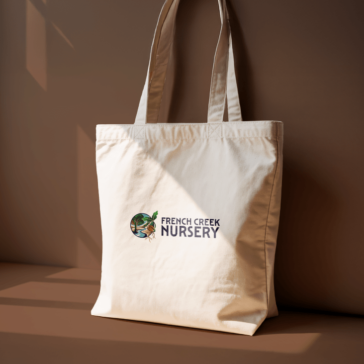 Logo displayed on a canvas tote bag sitting against a brown background.