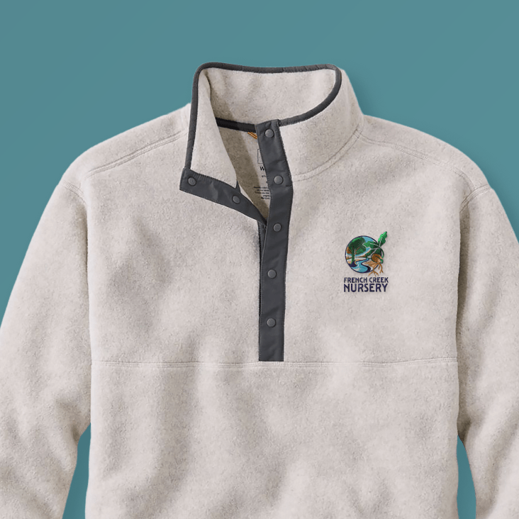 Logo displayed on a fleece quarter zip sweater against a blue background.